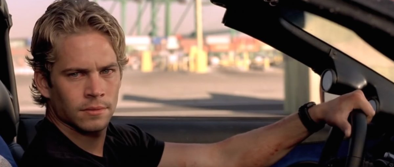 Walker as Brian O’Conner in the bright orange Toyota Supra he drove in the 2001 “The Fast And The Furious” movie. (Photo Credit: The Fast And The Furious/Universal Studios)